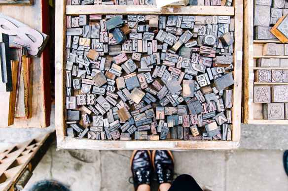 assorted wooden alphabets inside the crate
